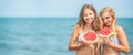 Young beautiful girl eating fresh watermelon on the tropical beach