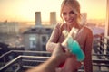 A young beautiful girl is enjoying a drink with some company on the terrace of an apartment. Leisure, home, together Royalty Free Stock Photo