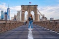 Young beautiful girl enjoying empty Brooklyn Bridge with a magical Manhattan island view Royalty Free Stock Photo