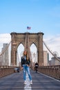 Young beautiful girl enjoying empty Brooklyn Bridge with a magical Manhattan island view Royalty Free Stock Photo