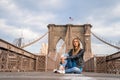 Young beautiful girl enjoying empty Brooklyn Bridge with a magical Manhattan island view Royalty Free Stock Photo