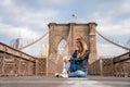 Young beautiful girl enjoying empty Brooklyn Bridge with a magical Manhattan island view Royalty Free Stock Photo