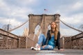 Young beautiful girl enjoying empty Brooklyn Bridge with a magical Manhattan island view Royalty Free Stock Photo