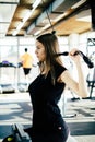 Young beautiful girl exercising in the fitness gym, with lat machine Royalty Free Stock Photo