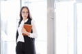 A young beautiful girl in eyeglasses enters glass office door. Royalty Free Stock Photo