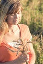 Young beautiful girl in the field with ears in the hand