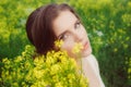 Young beautiful girl in field with yellow flowers Royalty Free Stock Photo