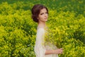 Young beautiful girl in field with yellow flowers Royalty Free Stock Photo