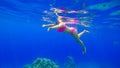 Young beautiful girl with a beautiful figure swims in the red sea is engaged in snorkeling Royalty Free Stock Photo