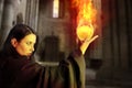 Young beautiful girl with fire sphere, sorcerer Royalty Free Stock Photo