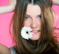 Young beautiful girl with flower in her mouth Royalty Free Stock Photo