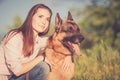 Young beautiful girl with a German shepherd playing on the lawn Royalty Free Stock Photo