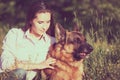 Young beautiful girl with a German shepherd playing on the lawn Royalty Free Stock Photo