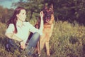 Young beautiful girl with a German shepherd playing on the lawn Royalty Free Stock Photo