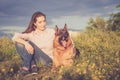 Young beautiful girl with a German shepherd playing on the lawn Royalty Free Stock Photo