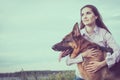 Young beautiful girl with a German shepherd playing on the lawn Royalty Free Stock Photo