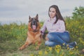 Young beautiful girl with a German shepherd playing on the lawn Royalty Free Stock Photo