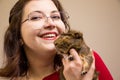 Young beautiful girl in glasses with her cute funny guinea pig Royalty Free Stock Photo