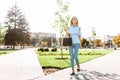 Young beautiful girl with glasses, student strolling in the Park