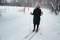 Young beautiful girl go skiing in winter season on a ski slope closeup Royalty Free Stock Photo