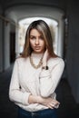 Young beautiful girl with a gold chain and retro clock posing on Royalty Free Stock Photo