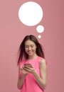 Young beautiful girl is happy with the services of a mobile operator and writes a review on the site from her smartphone