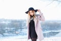 Young beautiful girl in hat and coat on a background of a winter Royalty Free Stock Photo