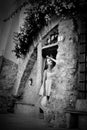 Young beautiful girl with hat posing near a vintage door Royalty Free Stock Photo