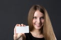 Young beautiful girl holding a business card in hand Royalty Free Stock Photo