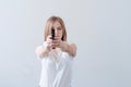 Young beautiful girl holding a gun in her hands. Aims at the camera Royalty Free Stock Photo