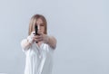 Young beautiful girl holding a gun in her hands. Aims at the camera Royalty Free Stock Photo