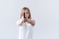 Young beautiful girl holding a gun in her hands. Aims at the camera Royalty Free Stock Photo