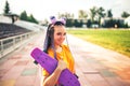 Young beautiful girl holding a skateboard in a hand in a yellow t-shirt in the open air at the stadium Royalty Free Stock Photo