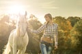 Young beautiful girl with a horse on the dry field Royalty Free Stock Photo