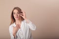 Young beautiful girl in the image of a teacher. in glasses and a white blouse. straightens the glasses. surprised. funny gestures Royalty Free Stock Photo