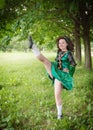 Young beautiful girl in irish dance dress dancing outdoor