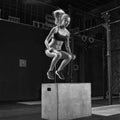 Woman doing a box jump at the gym Royalty Free Stock Photo