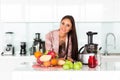 Young beautiful girl in the kitchen in the morning preparing fresh smoothies in a blender, modern kitchen, apartments, healthy Royalty Free Stock Photo