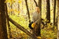 Young beautiful girl in a knitted sweater on the background of autumn park with fallen leaves Royalty Free Stock Photo