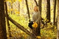 Young beautiful girl in a knitted sweater on the background of autumn park with fallen leaves Royalty Free Stock Photo