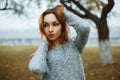 Young beautiful girl in a knitted sweater in a foggy autumn day Royalty Free Stock Photo