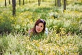 Young beautiful girl laying on the flowers field Royalty Free Stock Photo