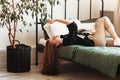 A young beautiful girl with long hair on a bed . Woman enjoying morning awakening . The concept of home coziness and comfort Royalty Free Stock Photo