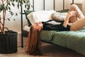 A young beautiful girl with long hair on a bed . Woman enjoying morning awakening . The concept of home coziness and comfort Royalty Free Stock Photo