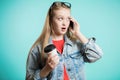 Young beautiful girl with long hair talking on mobile phone on blue background Royalty Free Stock Photo