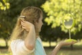 Young beautiful girl look into mirror in the park.Soft and blur conception. Royalty Free Stock Photo