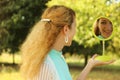 Young beautiful girl look into mirror in the park.Soft and blur conception Royalty Free Stock Photo