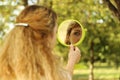 Young beautiful girl look into mirror in the park.Soft and blur conception Royalty Free Stock Photo