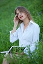 Young beautiful girl looks wistfully into the sky, sitting on th Royalty Free Stock Photo