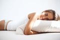 Young beautiful girl lying on bed early in morning.